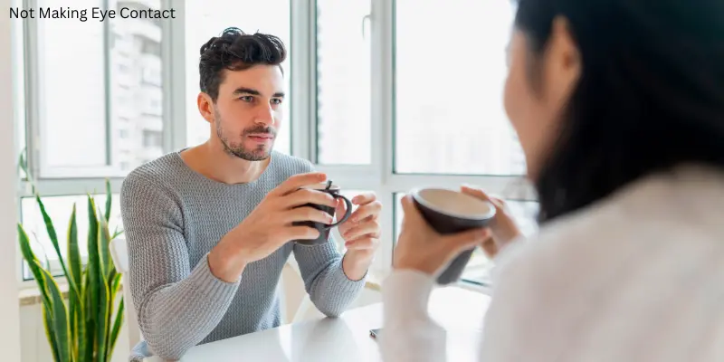 Woman Talking With A Man But He Is Not Making Eye Contact